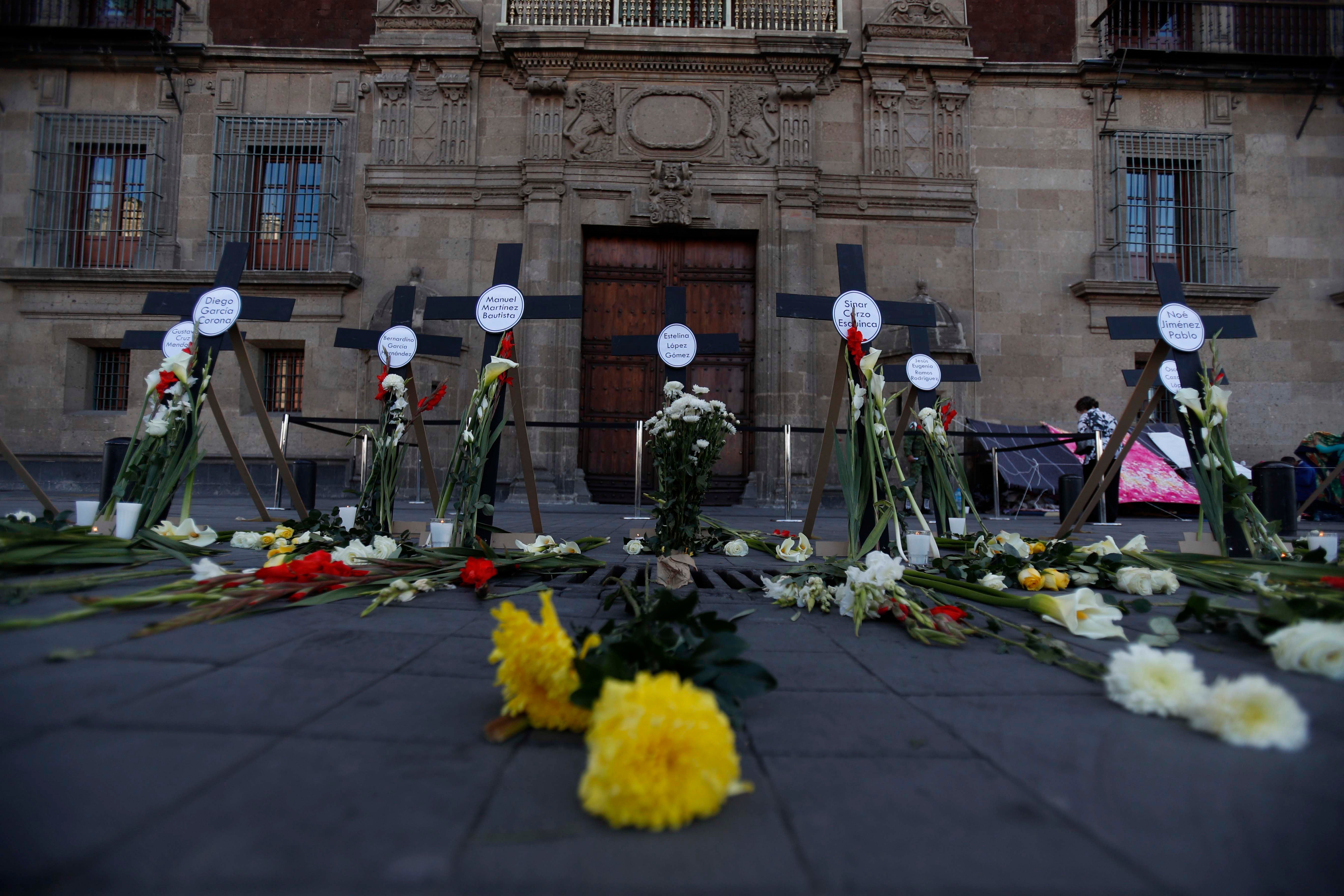 Crosses with the names of 14 journalists and human rights defenders who have been murdered since President Andres Manuel Lopez Obrador took office are pictured in front of the National Palace in Mexico City on Friday, February 22, 2019.