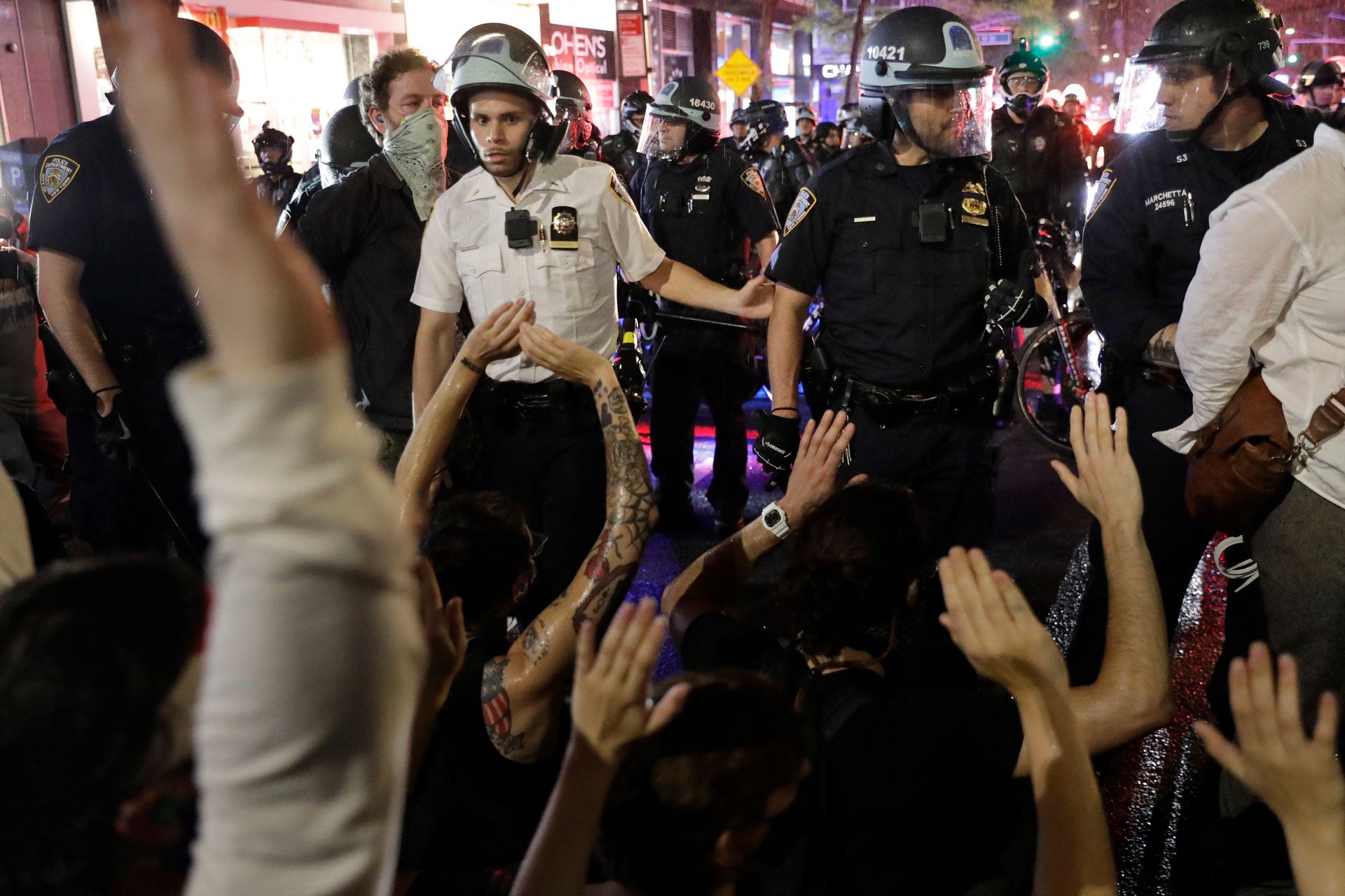 Police arrest protesters as they march through the streets of Manhattan, New York, Wednesday, June 3, 2020.