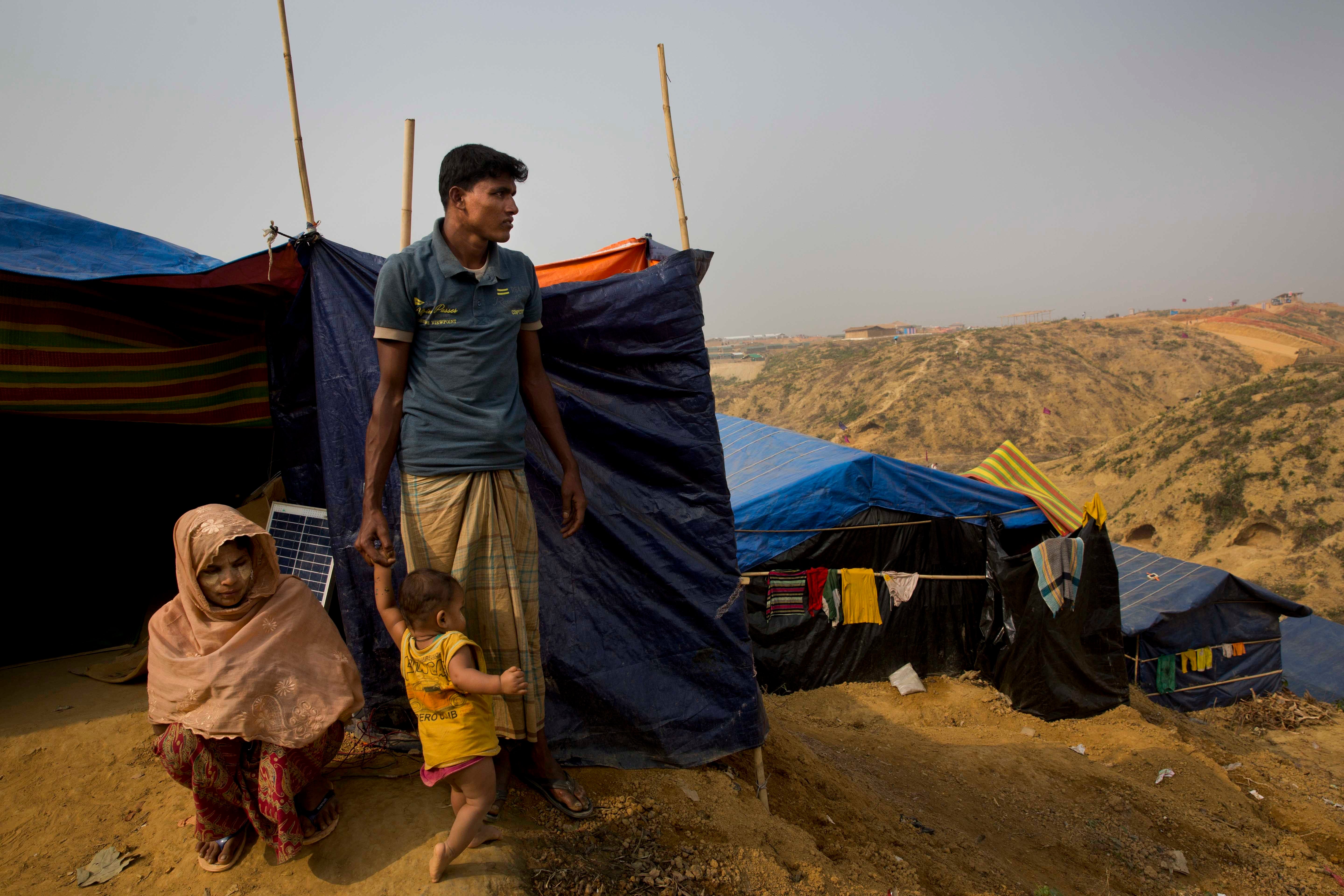 Rohingya refugees who fled the Myanmar village of Gu Dar Pyin stand on a hill in Kutupalong refugee camp, Bangladesh, January 14, 2018.
