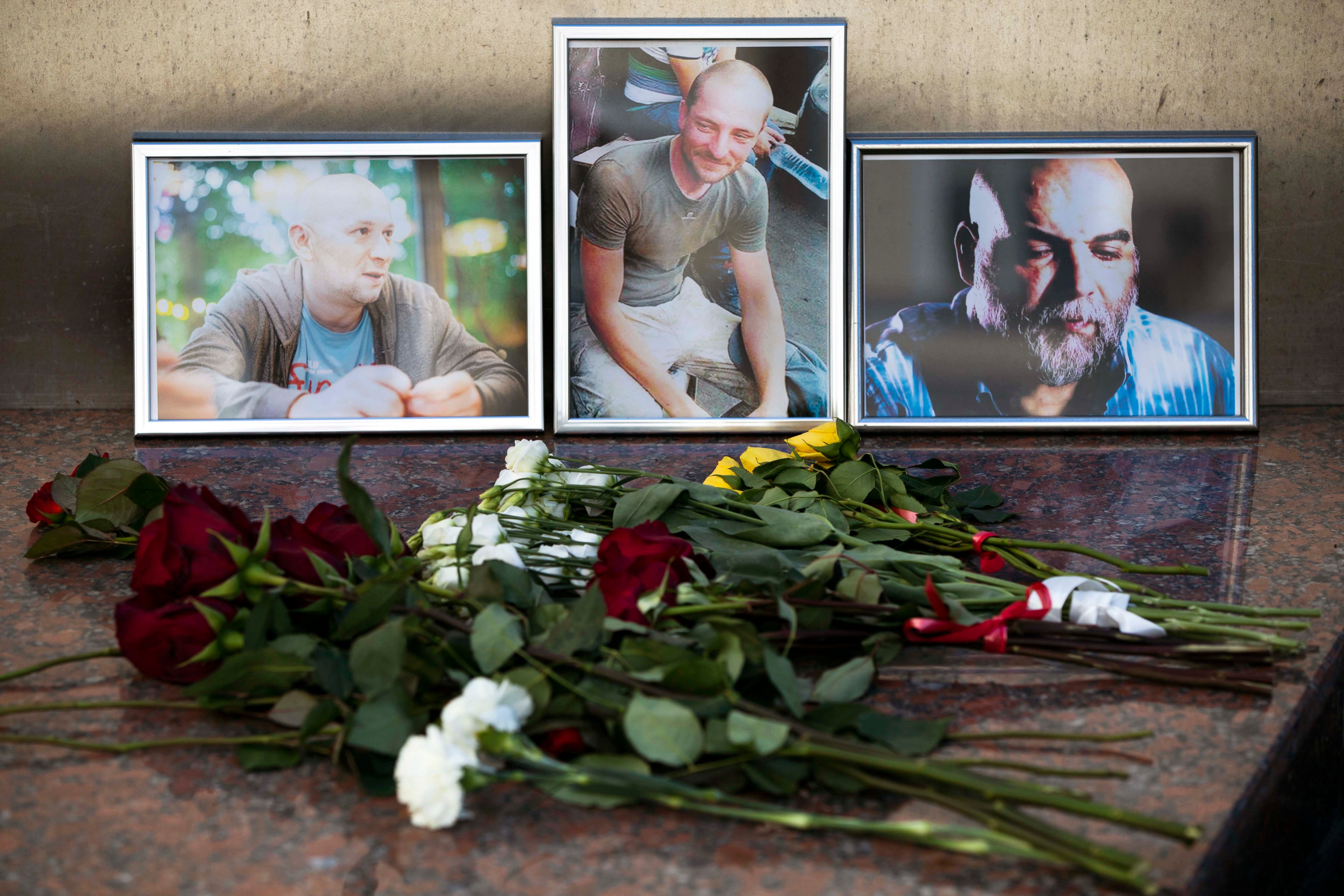 Flowers are placed by portraits of slain journalists Alexander Rastorguyev, Kirill Radchenko, and Orkhan Dzhemal, at the Russian Journalists’ Union building in Moscow on August 1, 2018.