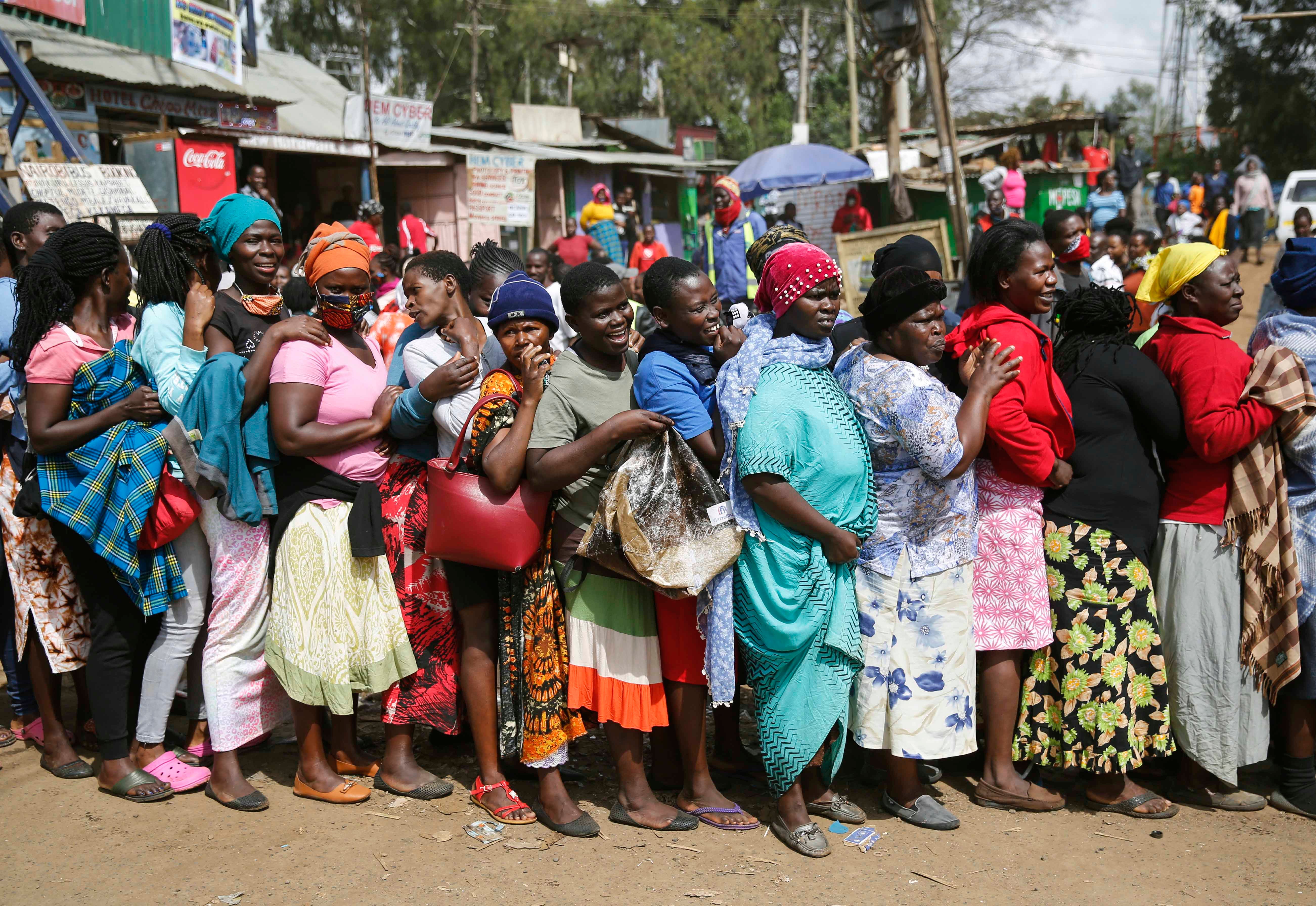 Woman stand outside in a closely packed line