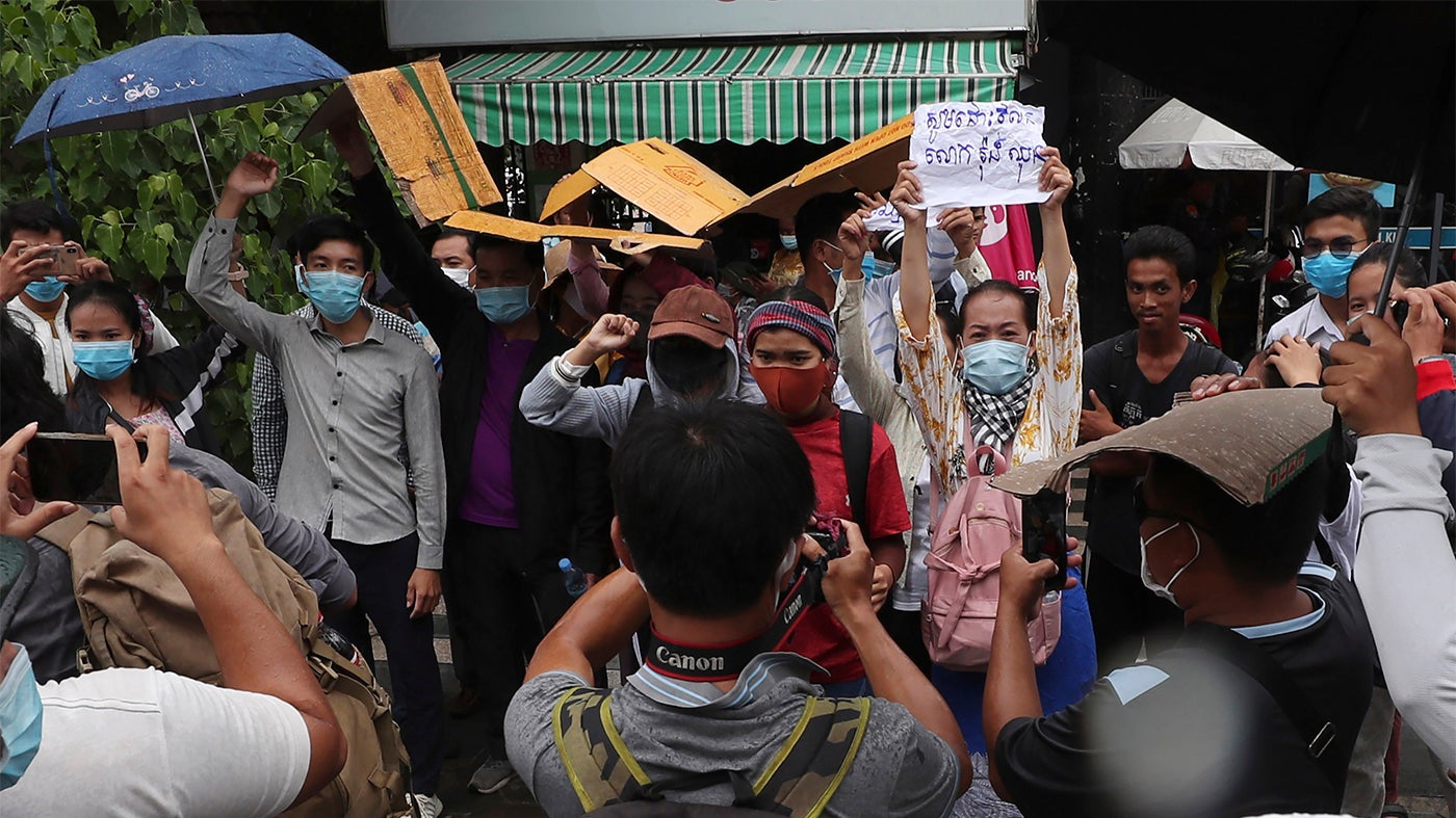 Supporters of Rong Chhun, president of the Cambodian Confederation of Unions, shout slogans in front of Phnom Penh Municipal Court in Phnom Penh, Cambodia on Saturday, August 1, 2020. 
