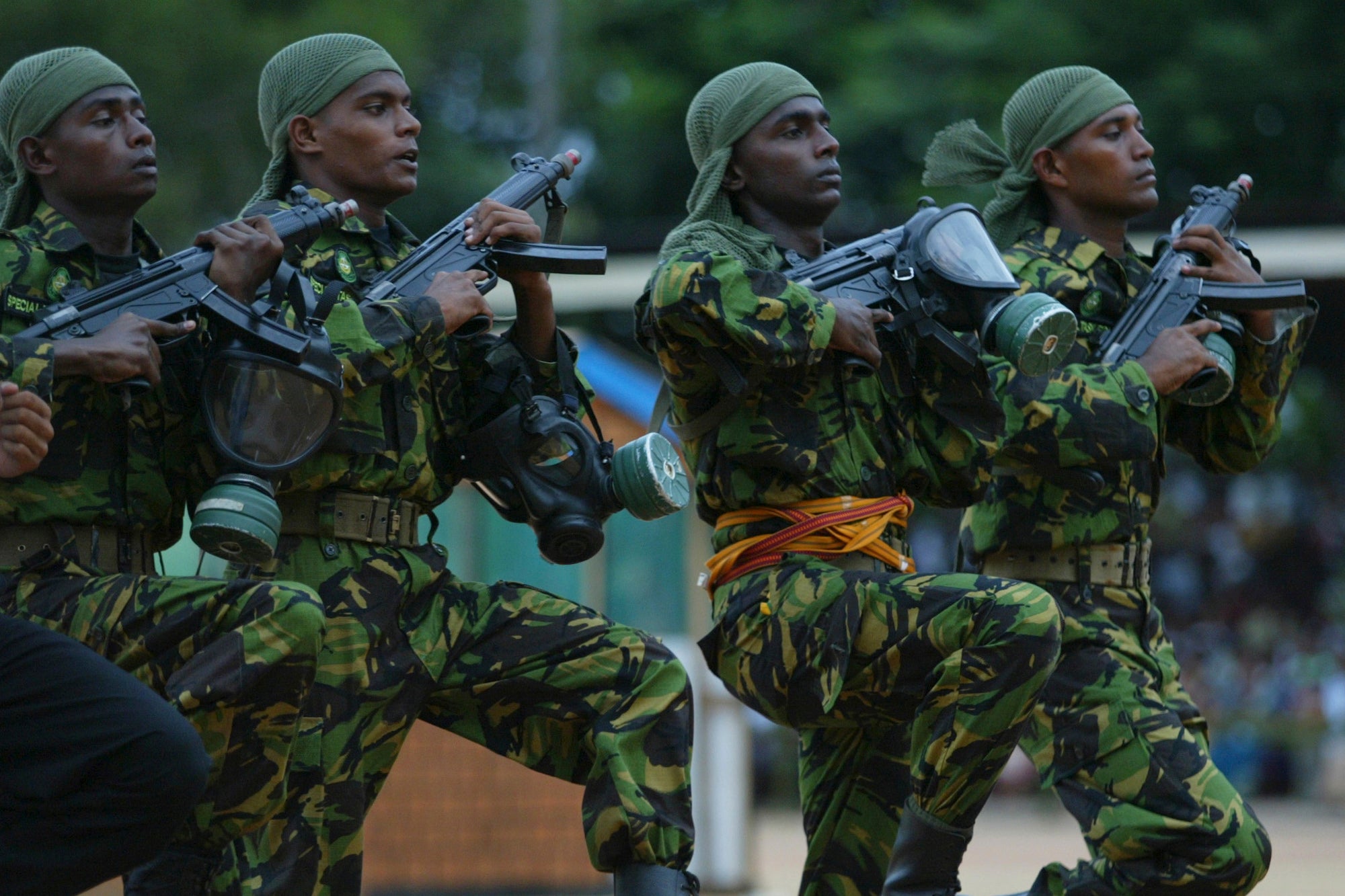 Four soldiers marching with guns