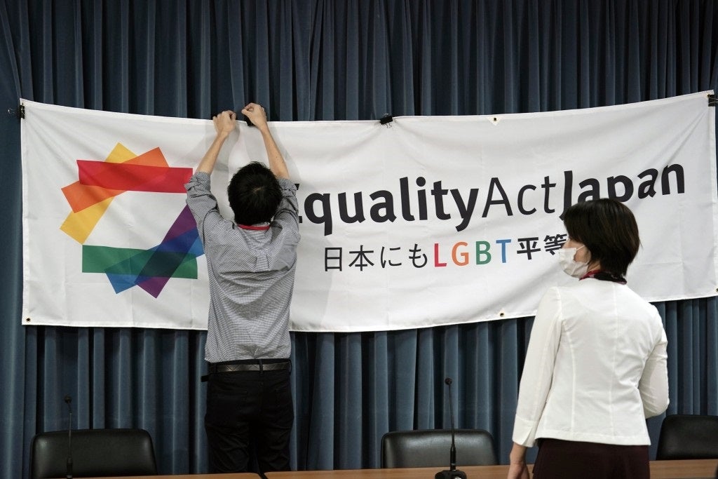A staff member adjusts a banner for a press conference to launch international signature campaign for the enactment of the "LGBT Equality Law" as a legacy of the Tokyo Olympics Thursday on October 15, 2020, in Tokyo.