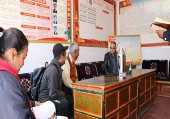 Three men and a woman sitting on a couch