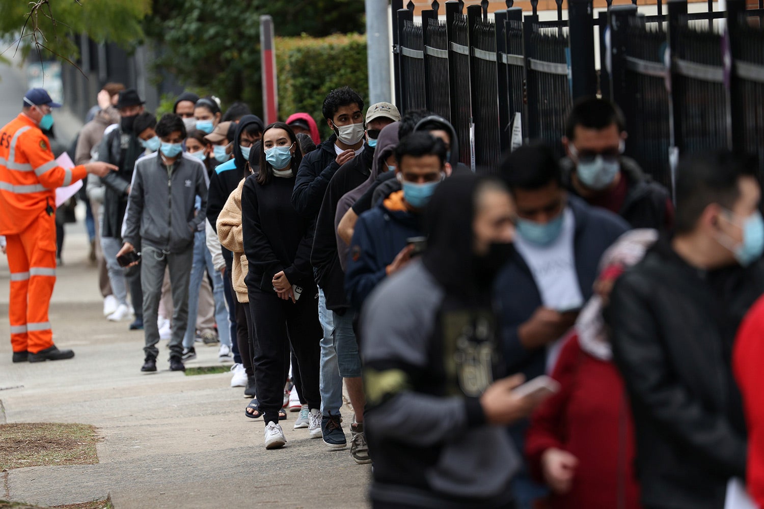 People wait outside a Covid-19 vaccination clinic in the Bankstown suburb during a lockdown in Sydney, Australia, August 25, 2021.