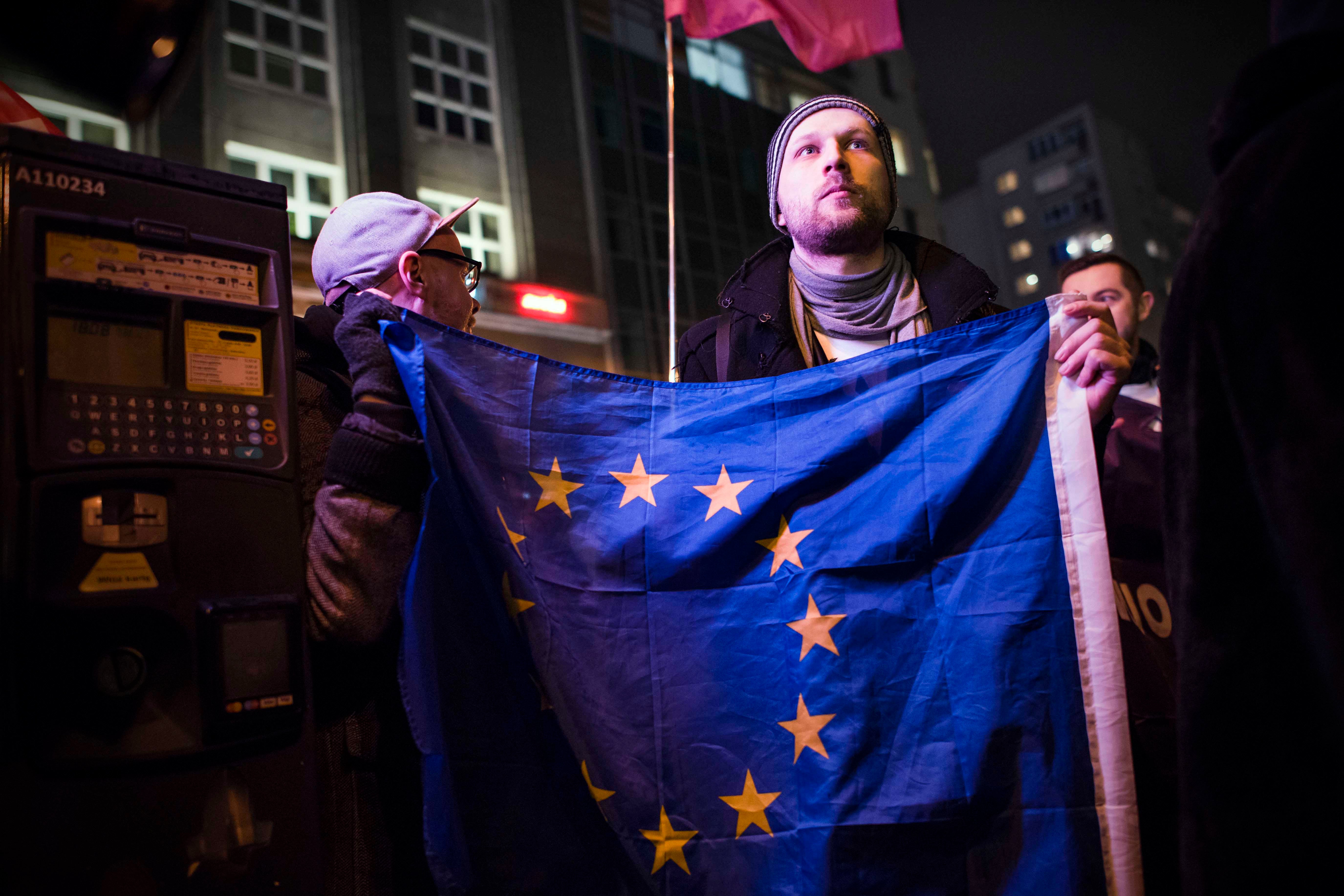 An activist holding the EU flag during a protest in Warsaw against “LGBT ideology free zones”. ©2021 Attila Husejnow / SOPA Images/Sipa USA