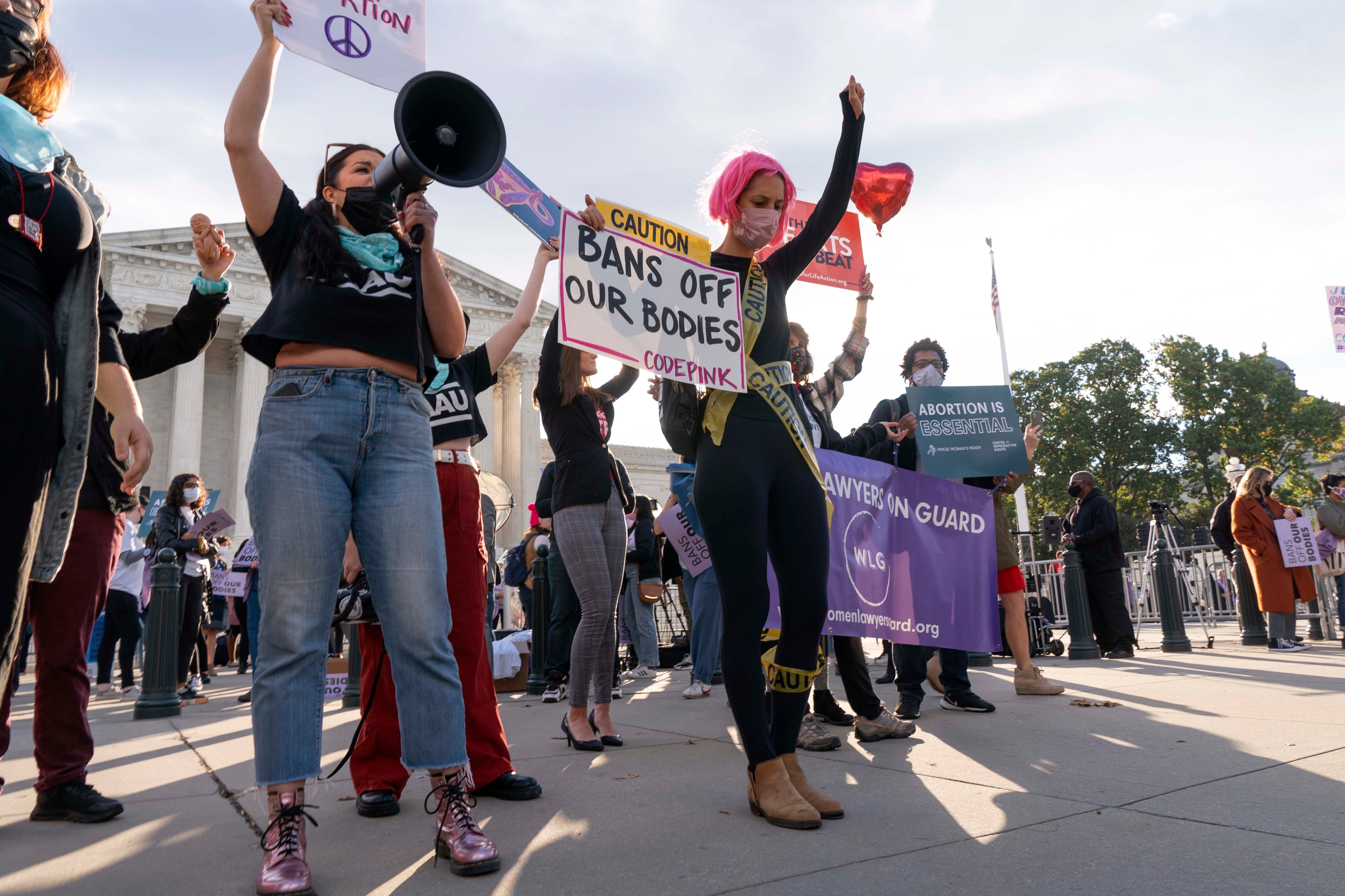 Women holding protest signs