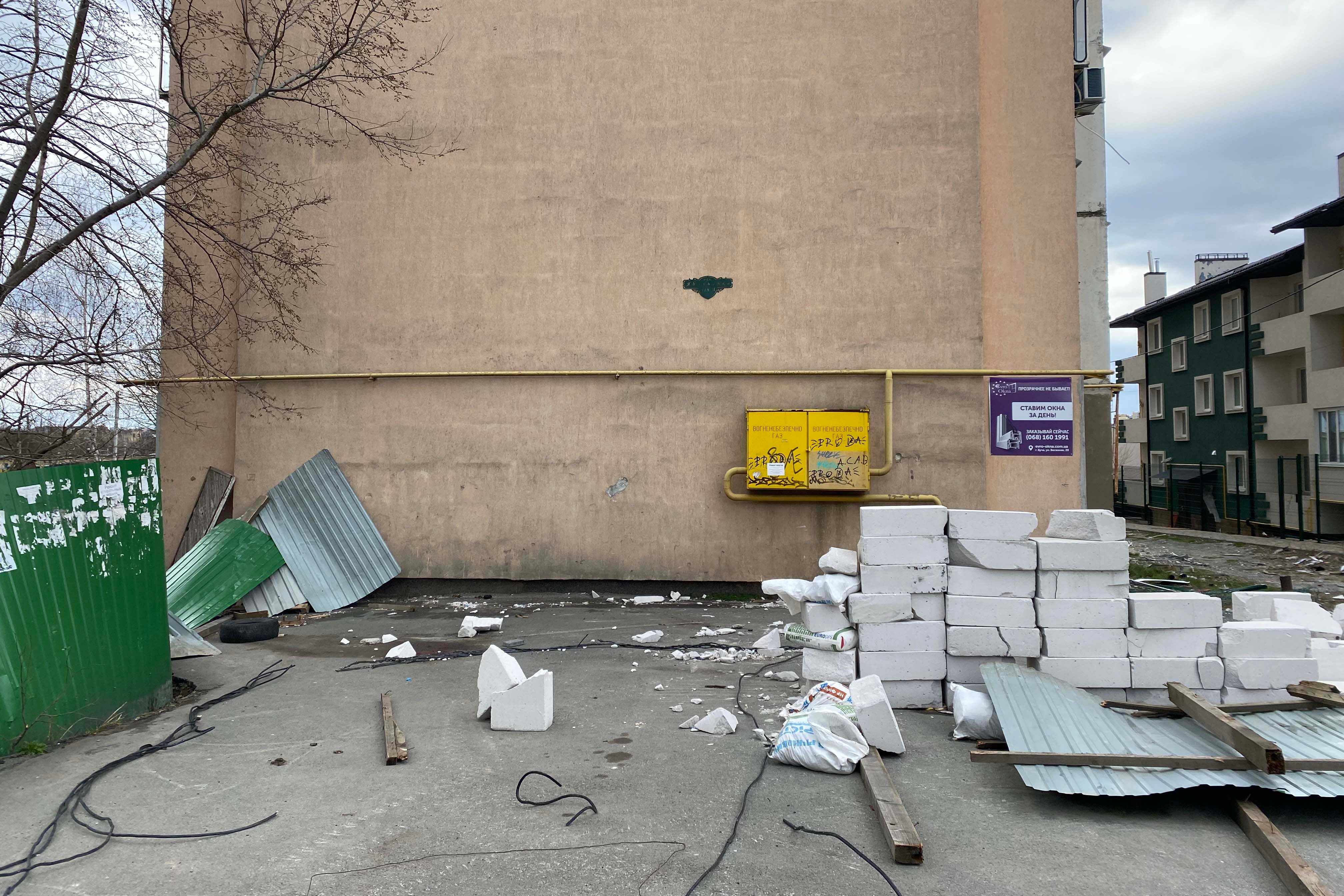 A large bloodstain remains where neighbors found the body of Oleh, 33, covered by metal sheeting