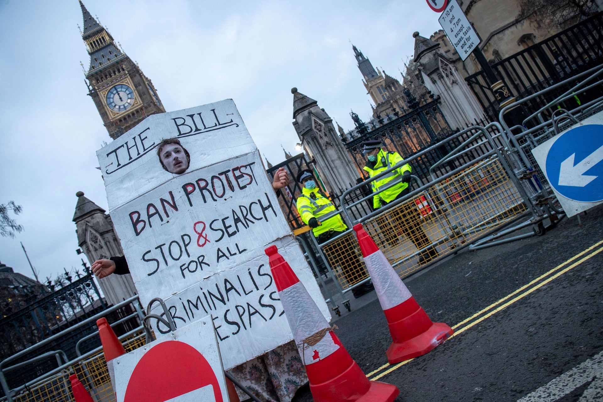 A protestor holds a sign outside the Houses of Parliament in London