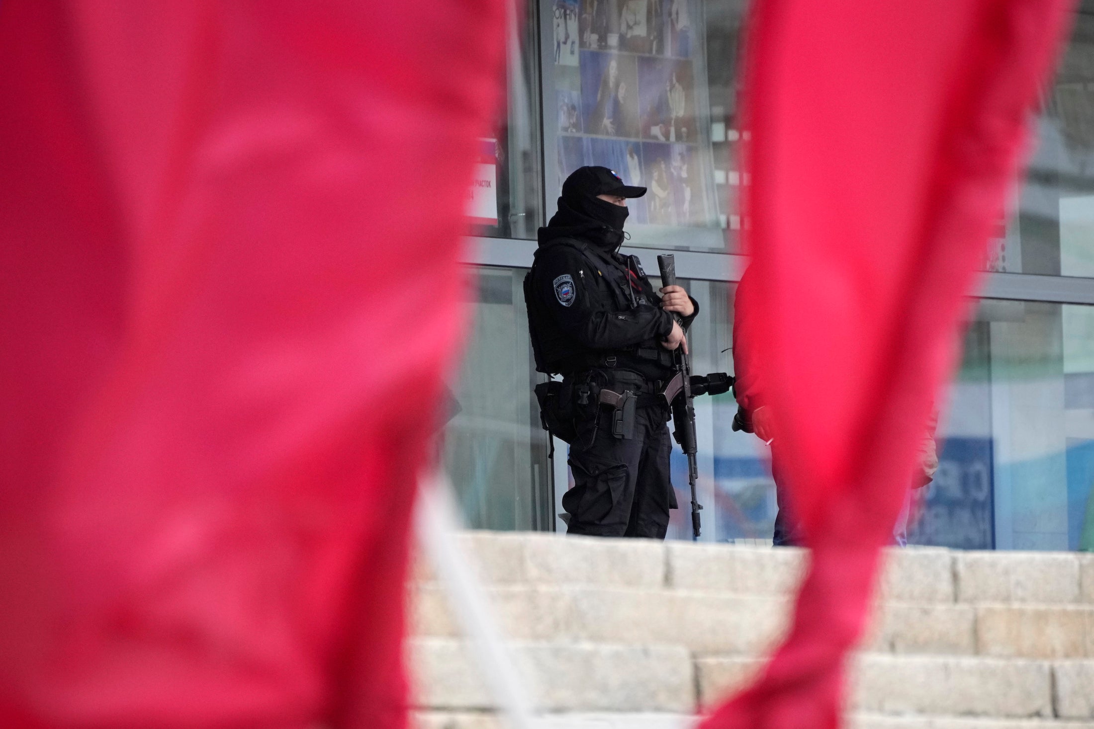 A Russian officer guards a polling station in the city of Luhansk, Ukraine, which is occupied by Russia.