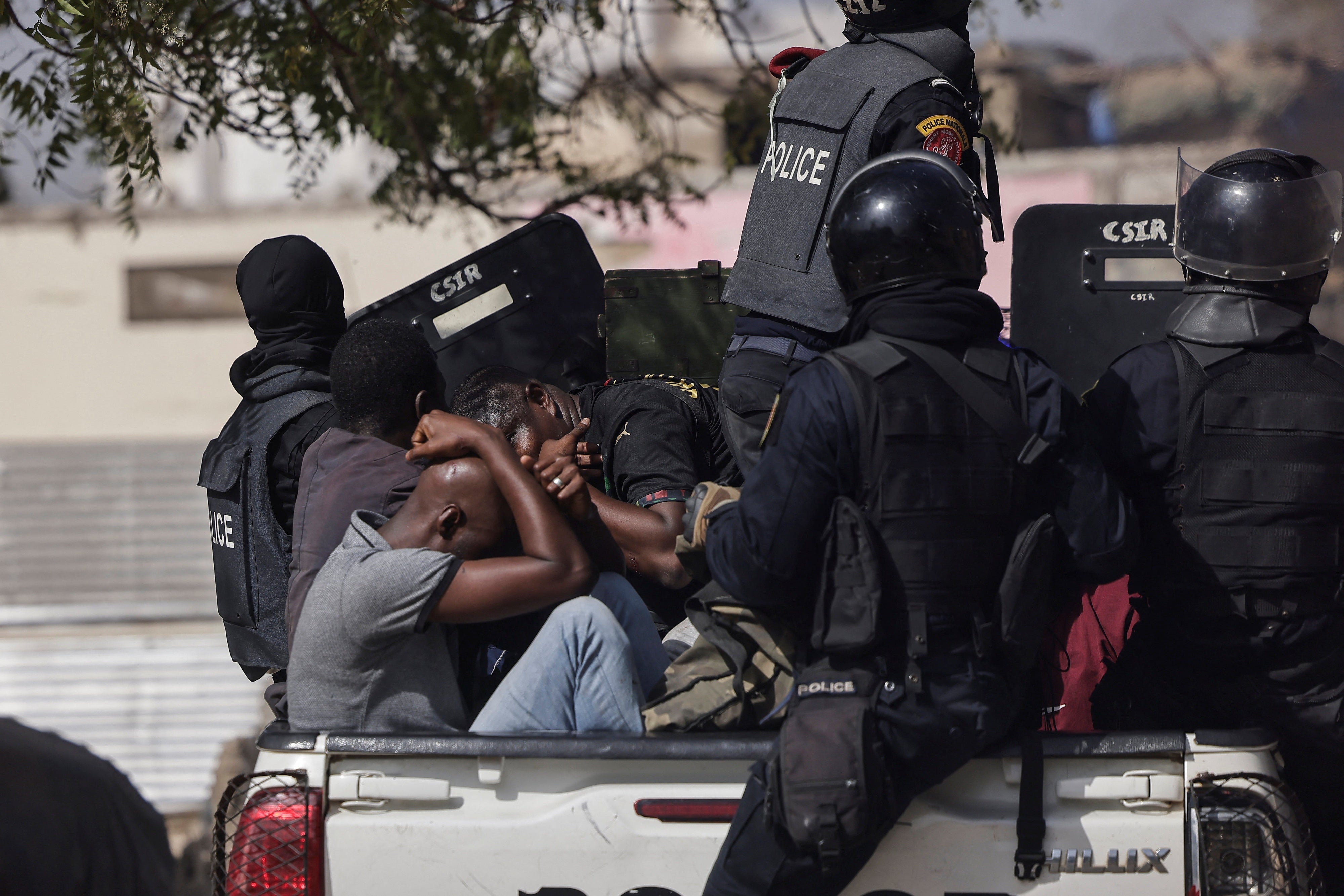 Detained demonstrators on a police pick up during a protest against the postponement of the February 25, 2024 presidential election, in Dakar, Senegal, on  February 9, 2024.