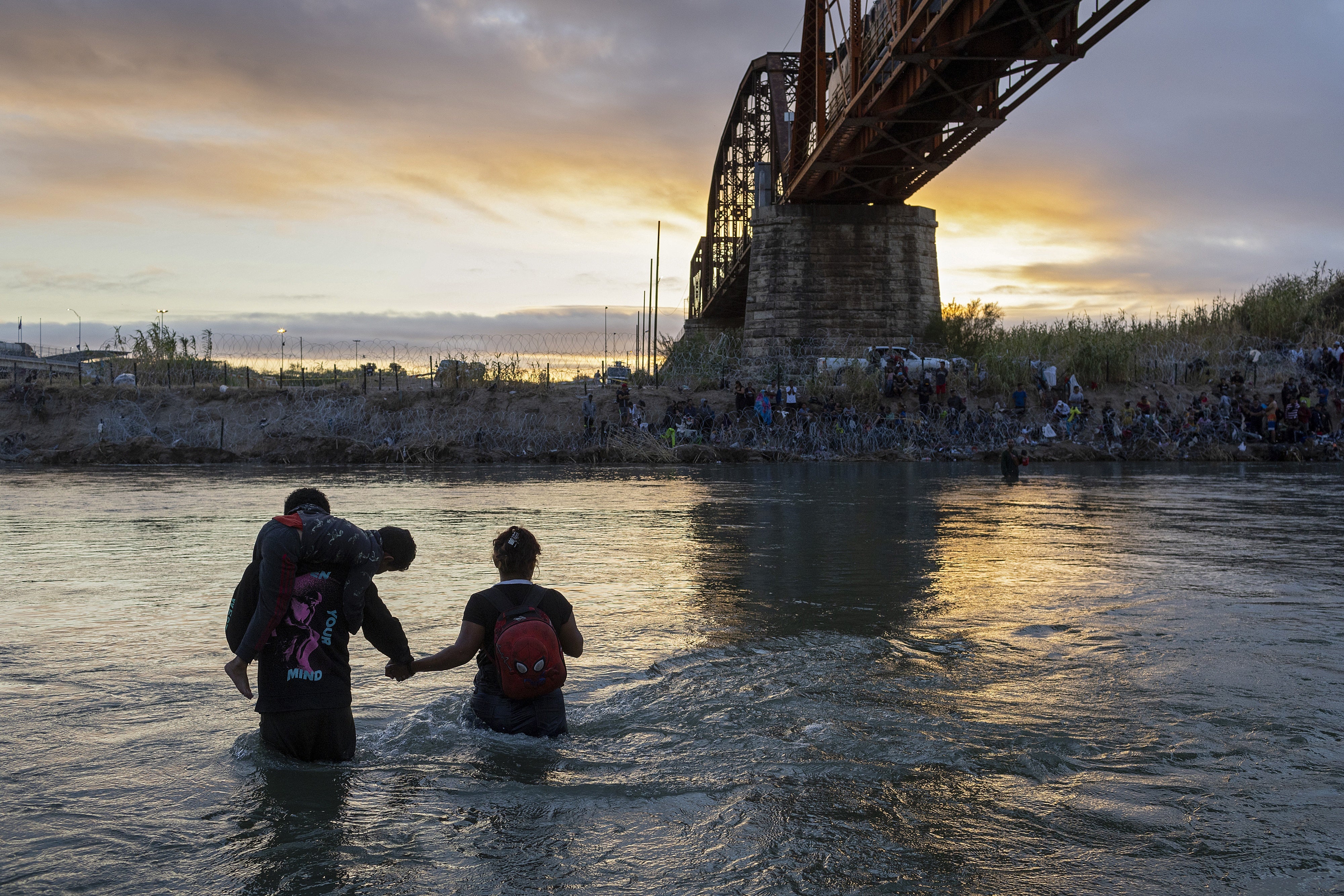 An immigrant family crosses the Rio Grande from Mexico into the United States on September 30, 2023 in Eagle Pass, Texas. 