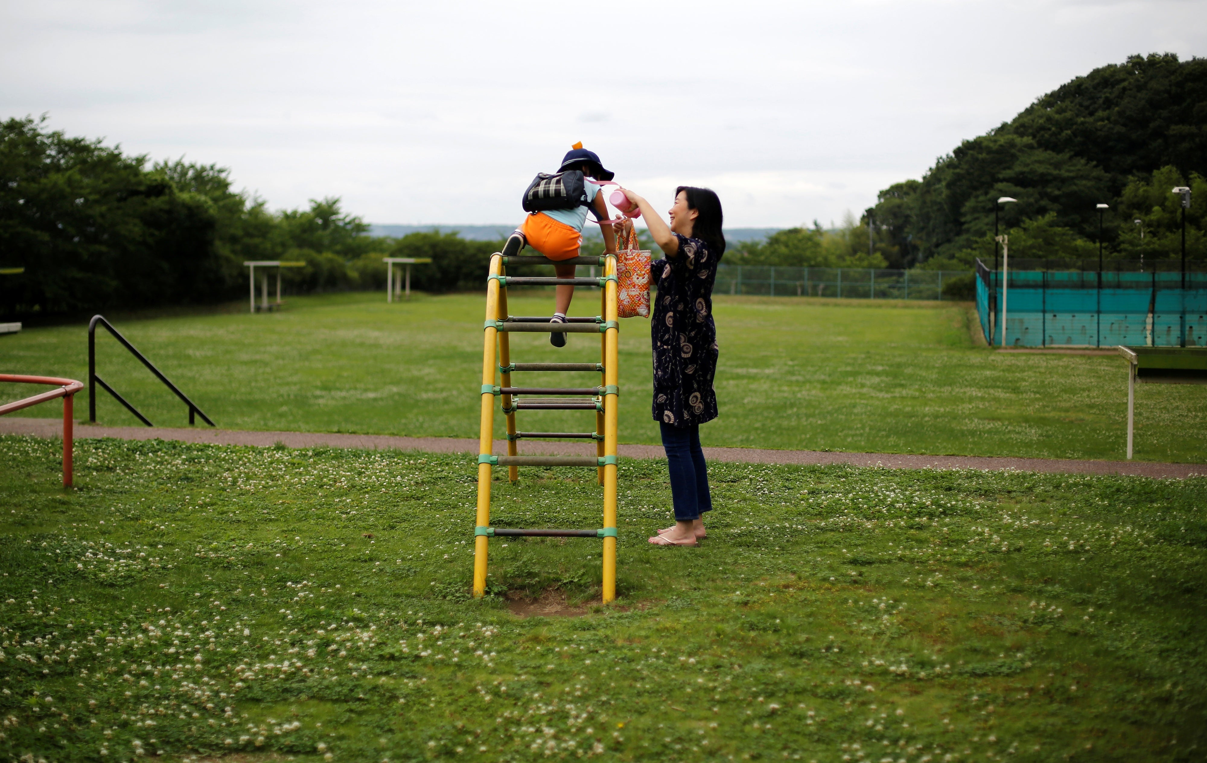 Foster mother Asako Yoshinari and her foster child at a park near her home in Inzai, Chiba prefecture, Japan, June 24, 2016.