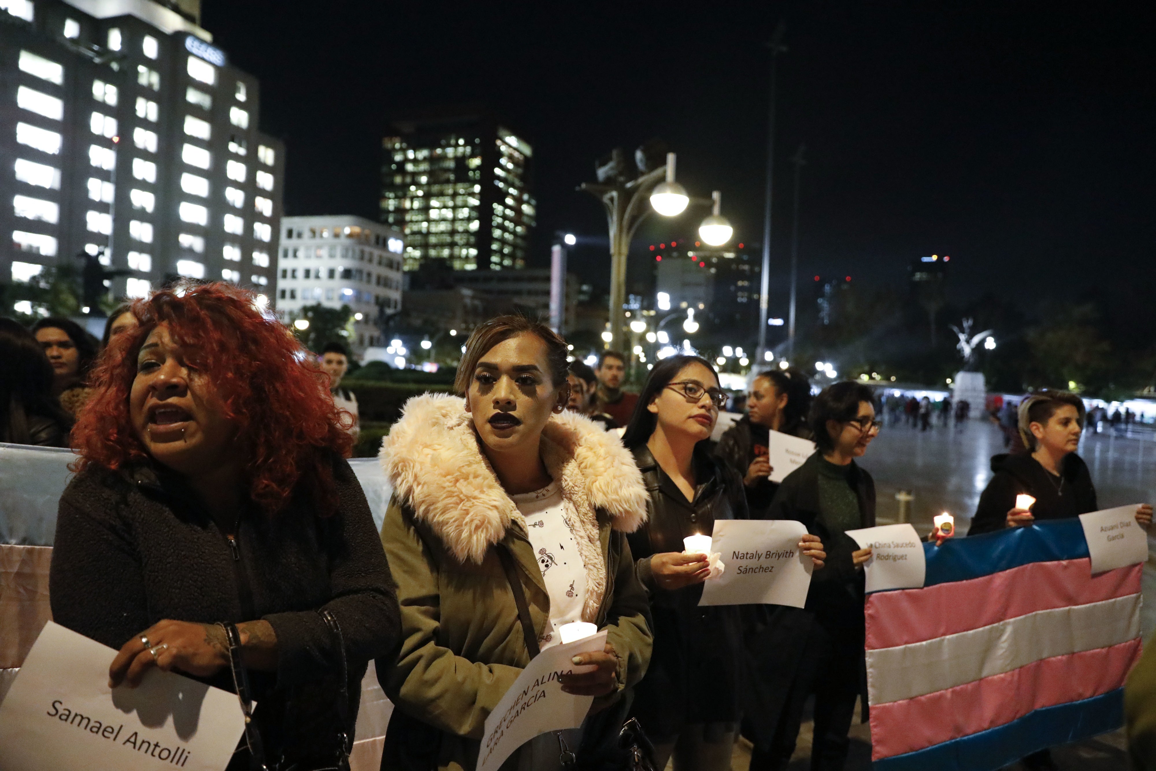  People carry the names of murdered transgendered women as dozens of transgender women and allies gather to commemorate murdered members of their community on Transgender Day of Remembrance in Mexico City.