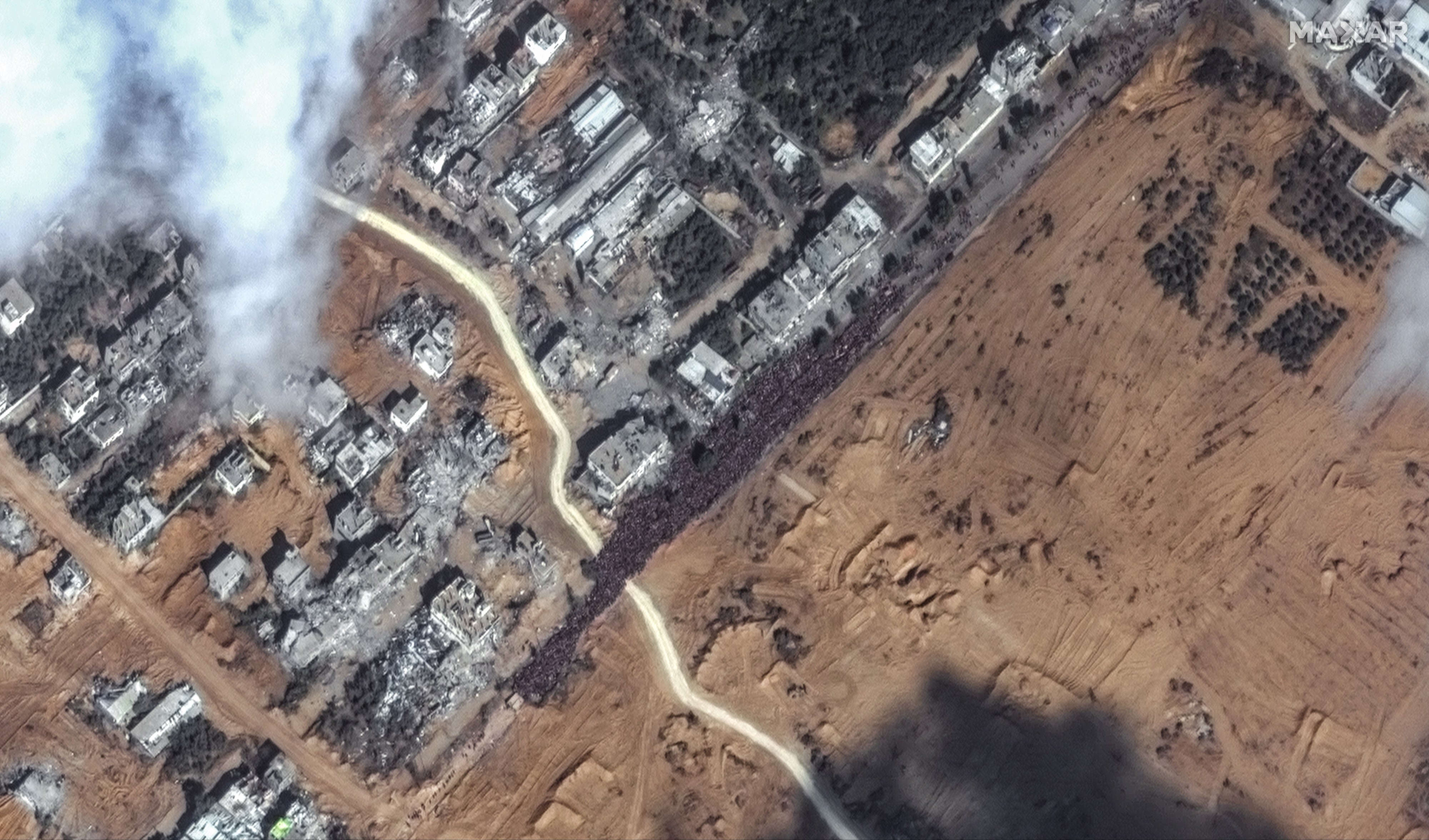 Satellite imagery shows a large crowd of people gathered along Salah al-Din Road in southern Gaza
