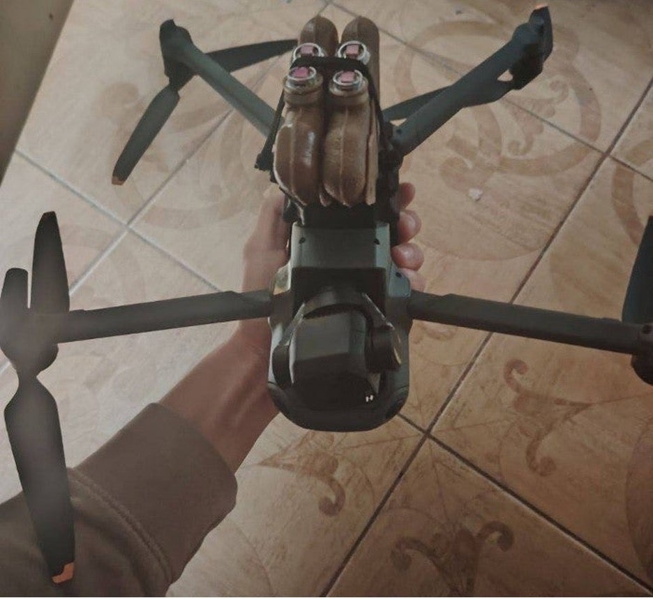 four PFM antipersonnel landmines attached to the underside of a DJI drone