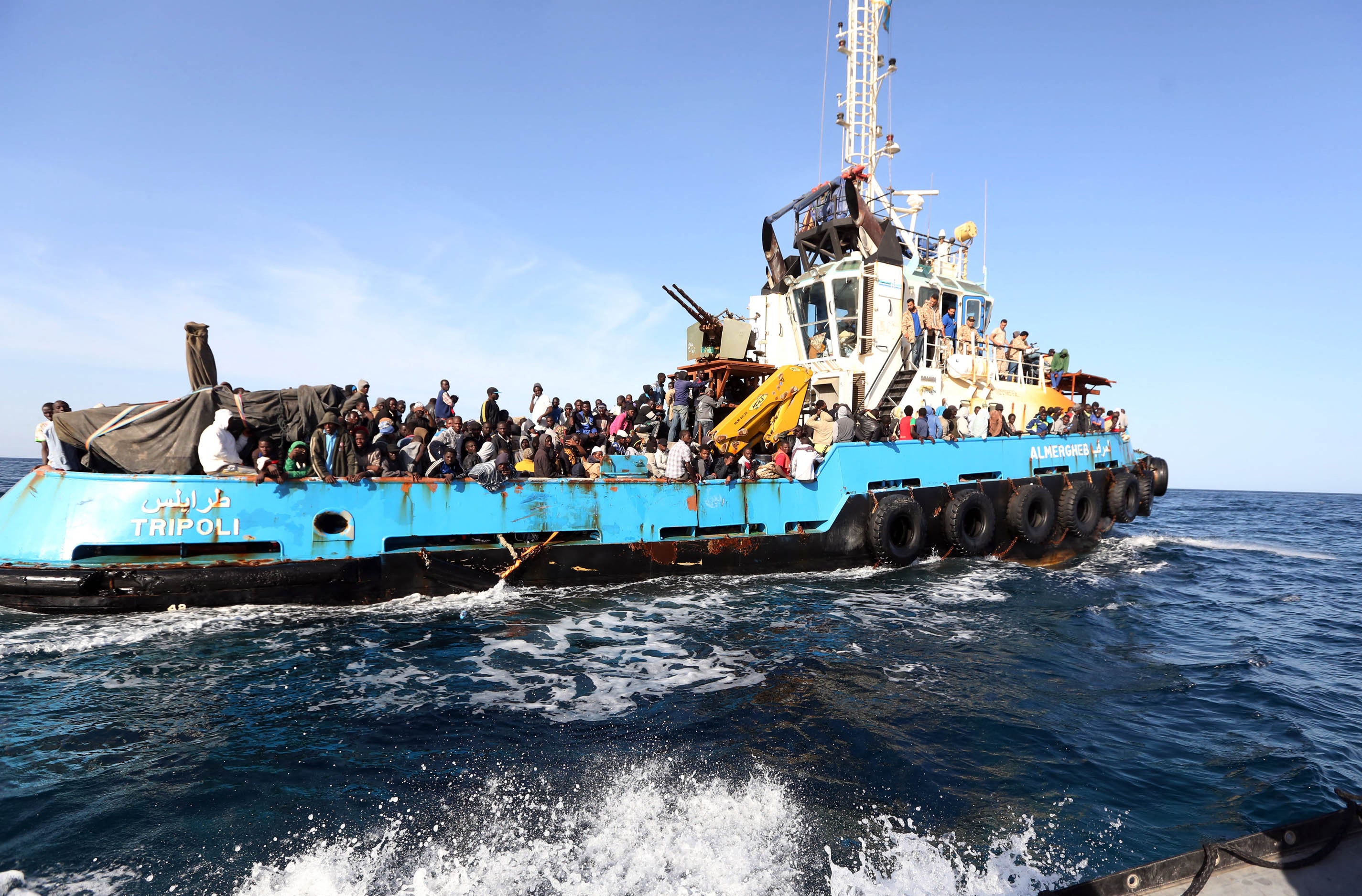 A Libyan coastguard boat carrying migrants arrive at the port in the city of Misrata on May 3, 2015, after the coastguard intercepted five boats carrying around 500 people trying to reach Europe.