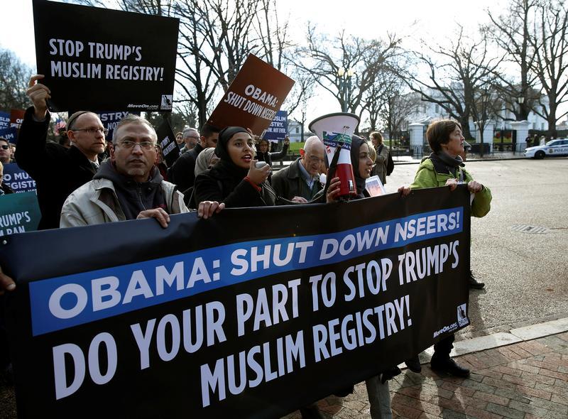 Protesters march past the White House during a protest to shut down the existing Muslim registry program NSEERS in Washington U.S., December 12, 2016.