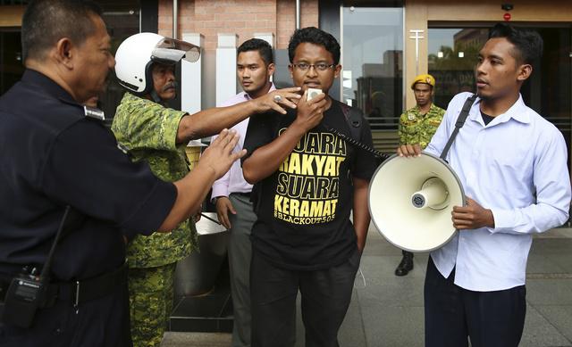 A university student leader calls for the repeal of the sedition act outside the Malaysian Ministry of Home Affairs building in Putrajaya on September 5, 2014.