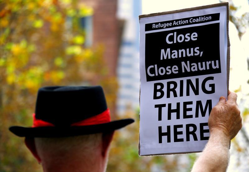 A protester from the Refugee Action Coalition holds a placard during a demonstration outside the offices of the Australian Government Department of Immigration and Border Protection in Sydney, Australia, April 29, 2016.