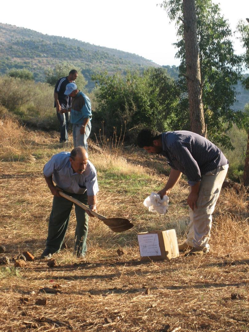 Two men collect the remains of 12-year-old Rami ‘Ali Hassan Shebli, who was killed on October 22, 2006 by a submunition leftover from a cluster munition attack on Halta in Lebanon. Rami unwittingly picked up the submunition while playing with his brother.