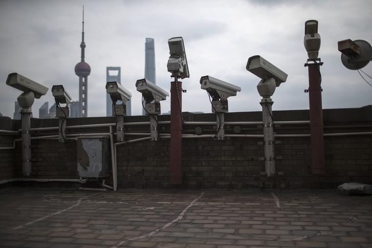 Security cameras are seen on a building at the Bund in front of the financial district of Pudong in Shanghai on March 6, 2015.
