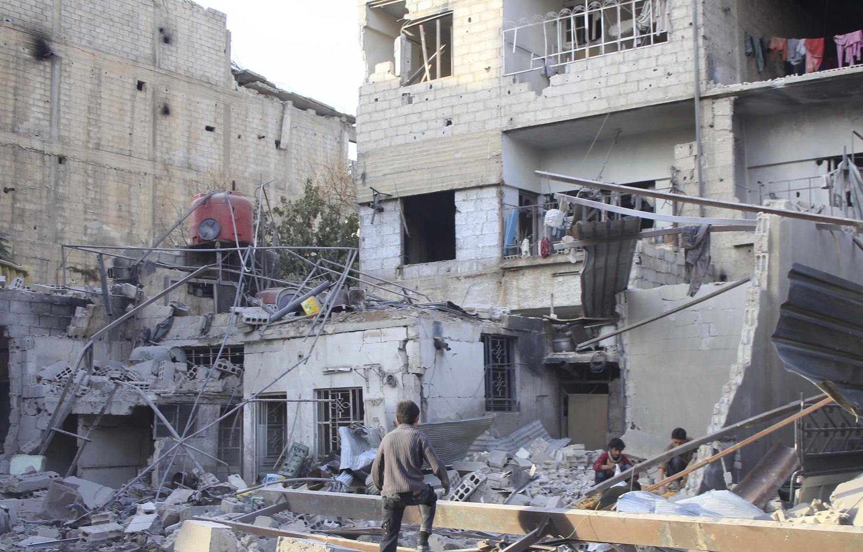 Children in the rubble of damaged buildings in the eastern Damascus suburb of Ghouta, Syria. 