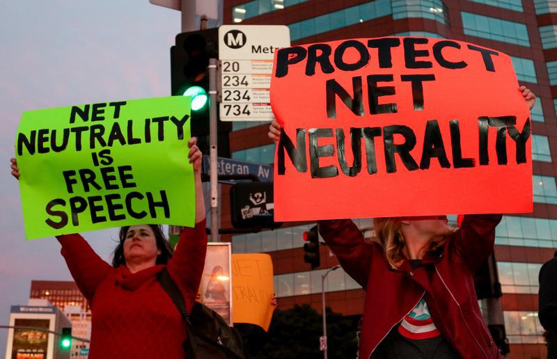 Supporter of Net Neutrality Ginger Gibson (L) of Valley Glen, California, protests the FCC's recent decision to repeal the program in Los Angeles, California, November 28, 2017.