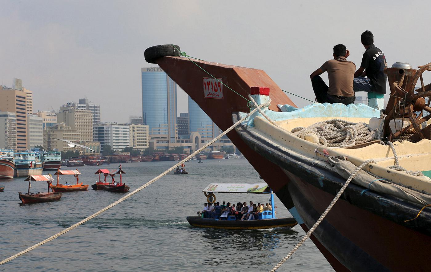 Iranian workers rest on a commercial ship at Dubai Creek, January 17, 2016. 