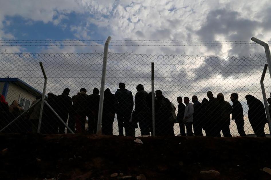 Displaced persons who fled fighting in Mosul gather at Khazir camp, in the Kurdistan Region of Iraq. 