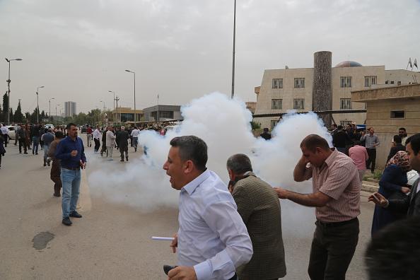 Riot police use teargas to disperse hundreds of civil servants who gathered during a protest against reduced monthly salaries in Erbil, Iraq on March 25, 2018. © 2018 Hemn Baban/Anadolu Agency/Getty Images