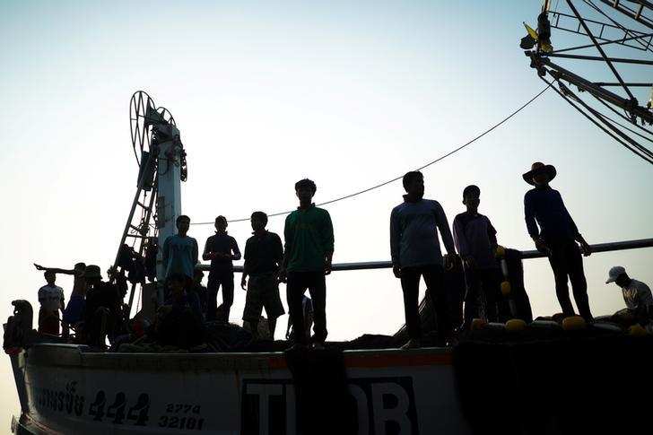 Migrant workers prepare to unload their catch at a port in Samut Sakhon province, Thailand, January 22, 2018. 