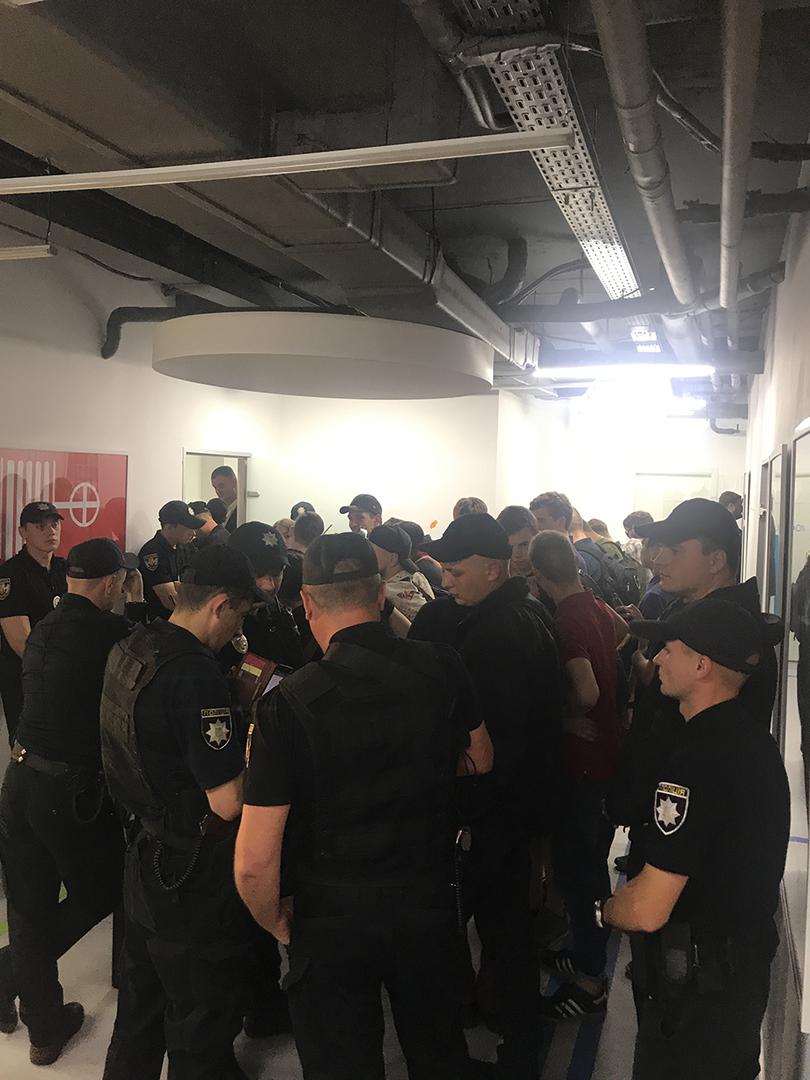 Police and members of radical groups outside the room where the event organized by Amnesty International Ukraine was supposed to take place. 