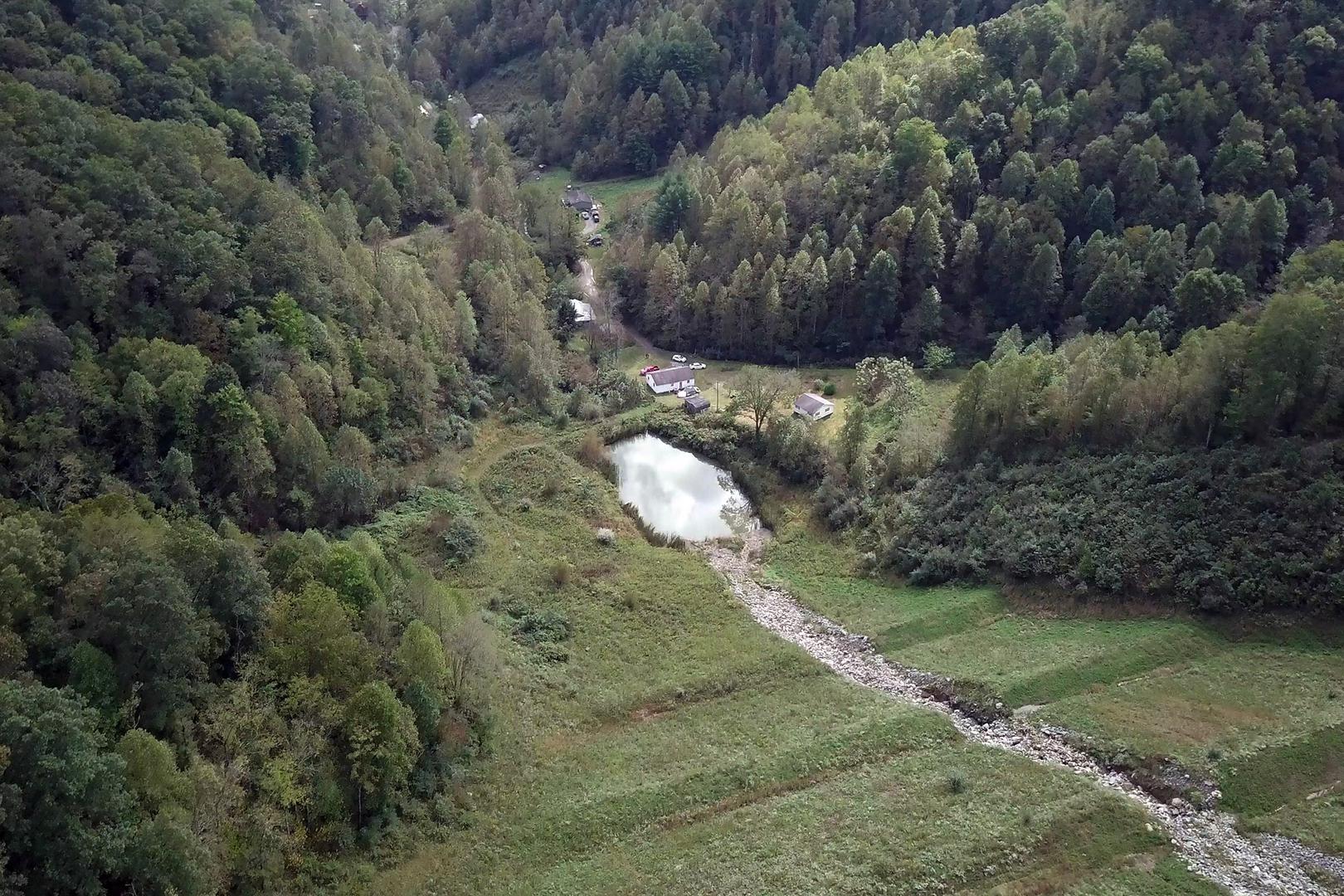 One of the mine’s valley fills. The rocks replace a buried stream and water collects in a sediment pond below, feeding into a stream that runs alongside a row of homes, all of which rely on private wells.