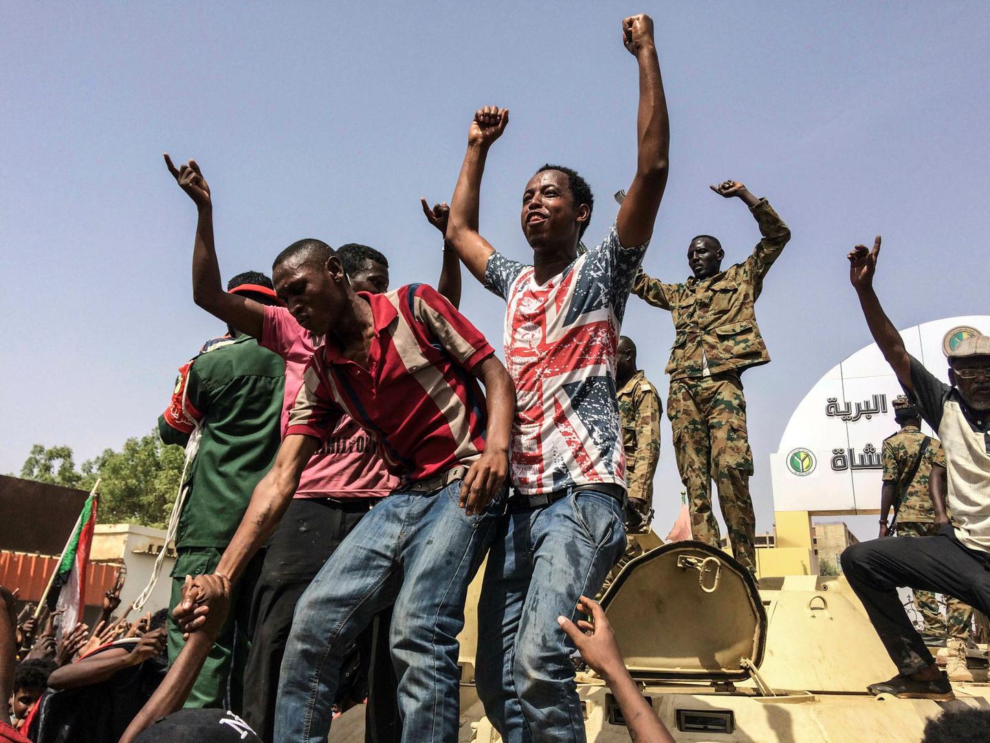 Sudanese celebrate after officials said the military had forced longtime autocratic President Omar al-Bashir to step down after 30 years in power in Khartoum, Sudan, Thursday, April 11, 2019.