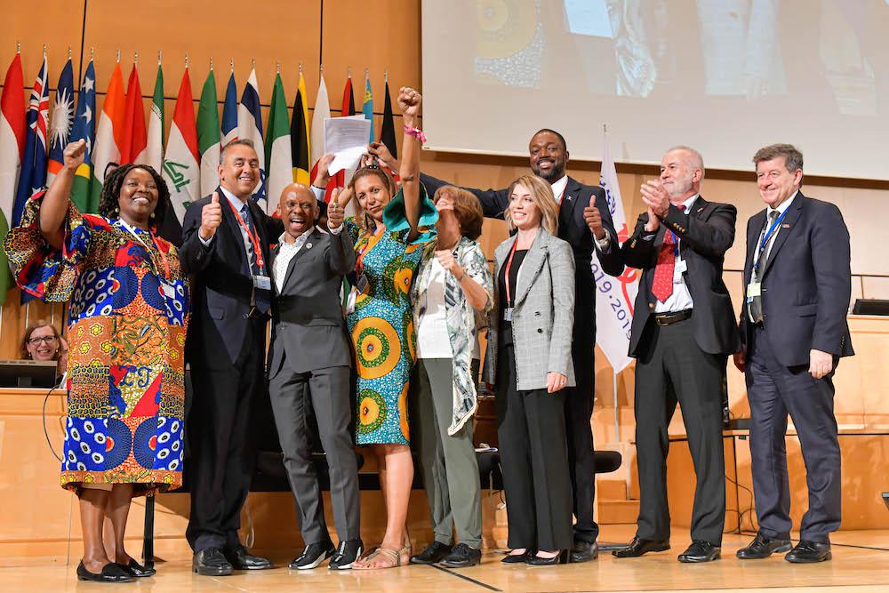 Marie Clarke-Walker (center) celebrates the final record vote on the Convention concerning the elimination of violence and harassment in the world of work.