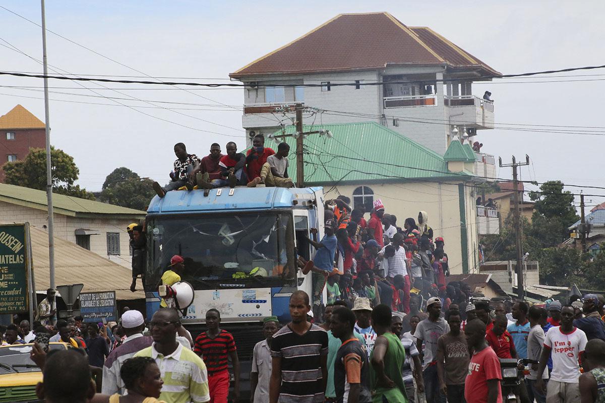 People protest on the streets of Conakry, Guinea, Thursday, Oct. 24, 2019. 