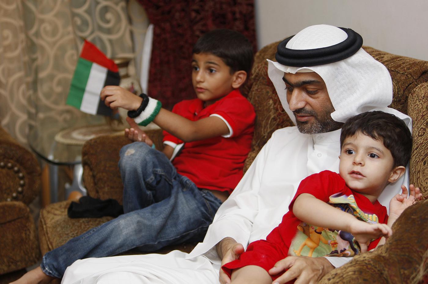 Ahmed Mansoor, one of the five political activists pardoned by the United Arab Emirates, plays with his children as he speaks to Reuters in Dubai on November 30, 2011. 