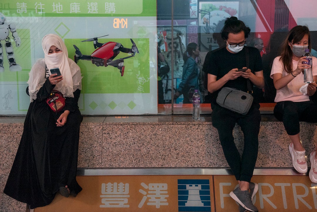 Residents use their phones during a protest in Hong Kong, November 11, 2019.