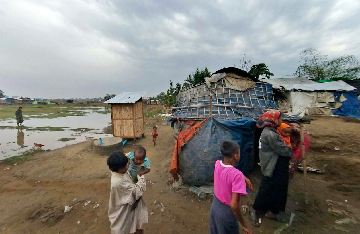 Rohingya walk at Dar Paing camp, Rakhine State, Myanmar, March 17, 2017.