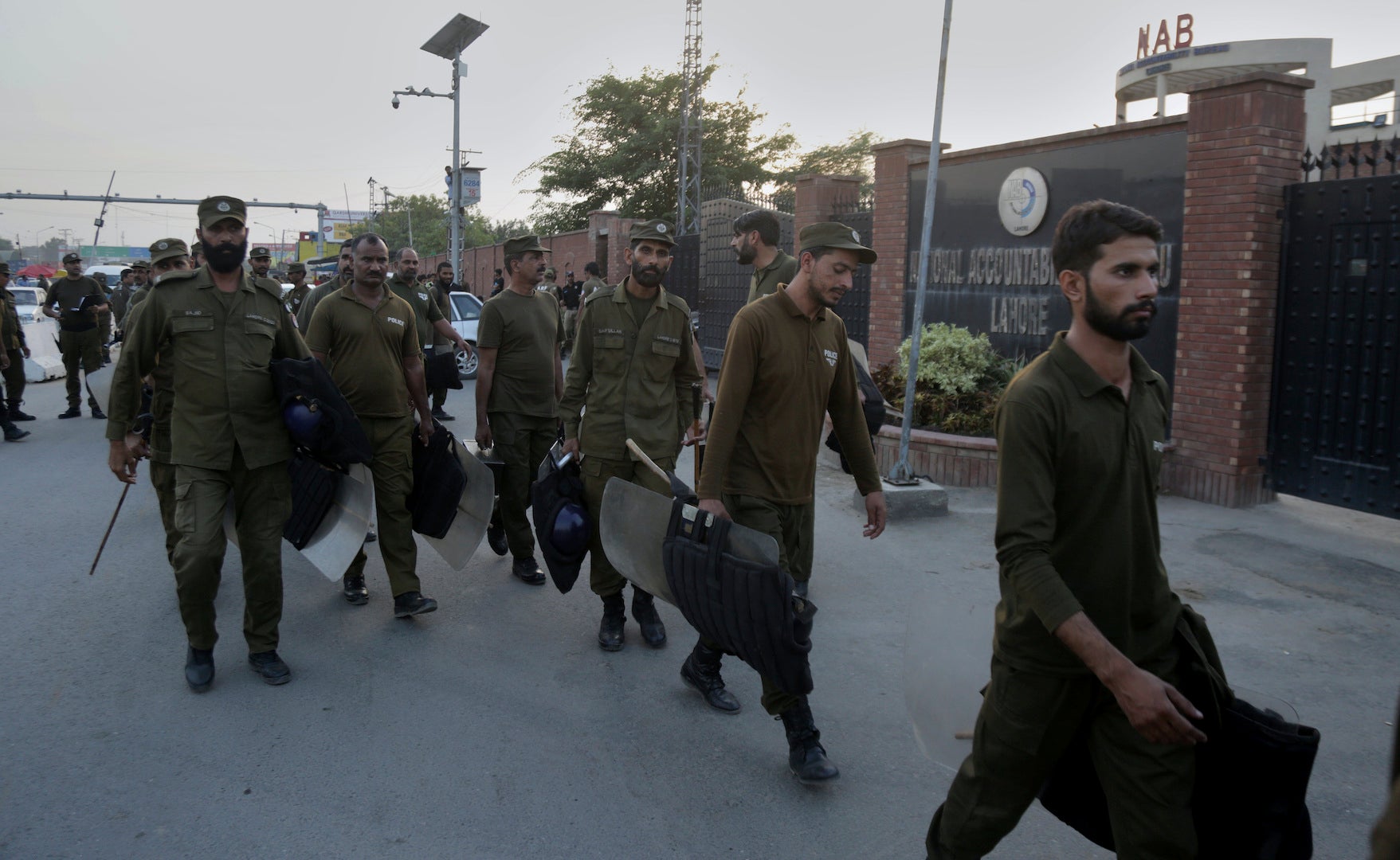 Police officers arrive at the office of the National Accountability Bureau, Lahore, Pakistan, October 5, 2018.