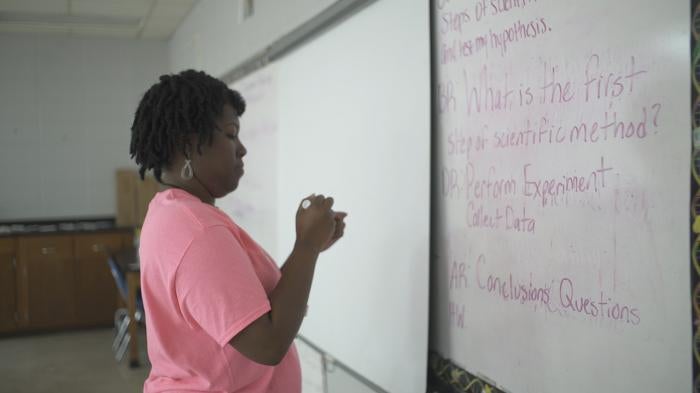 Woman at white board