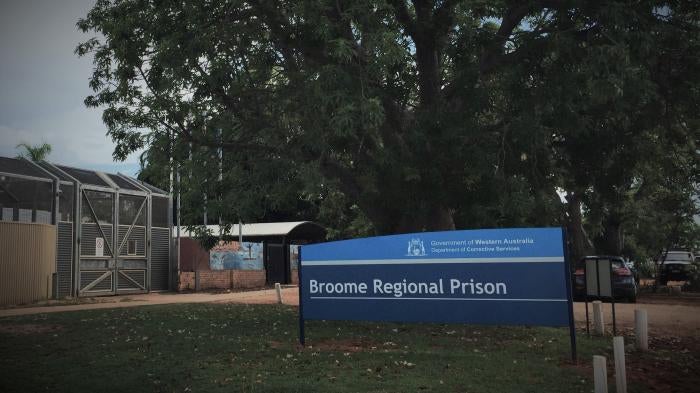 The exterior of a prison, with a sign that reads "Broome Regional Prison"