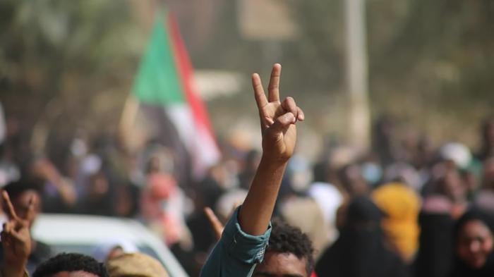 Pro-democracy protesters flash the victory sign as they take to the streets to condemn a takeover by military officials, in Khartoum, Sudan, October 25, 2021. 