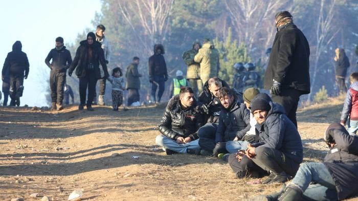 A group of men seated on the ground 