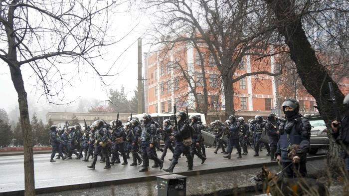 Kazakh riot police walk to block demonstrators gathering during a protest in Almaty, Kazakhstan, January 5, 2022. 