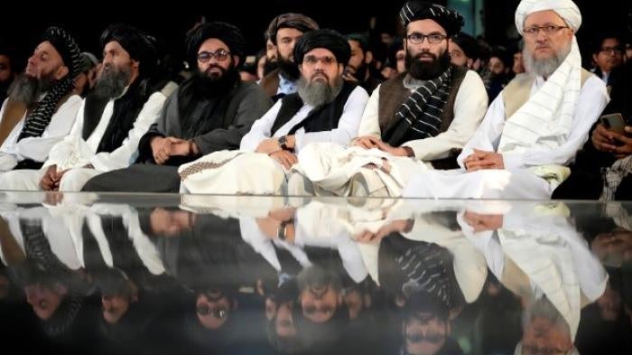 Taliban leaders sit in a row at a ceremony