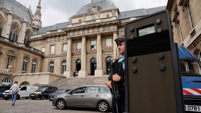 A French gendarme stands guard at Paris' criminal courthouse, August 26, 2022. 