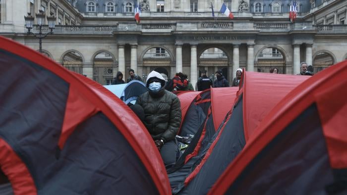 More than 200 young refugees demonstrate in front of the State Council building in Paris, December 2, 2022.  Many have been sleeping, some for 6 months or longer, under the bridges in Ivry-sur-Seine, on the outskirts of Paris.